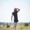Woman in a field wearing eco responsable sportswear
